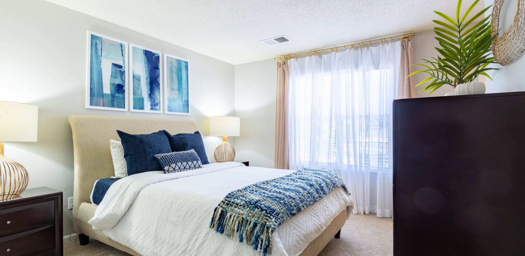 Hawthorne at the Park apartment bedroom with large window and carpet floor.